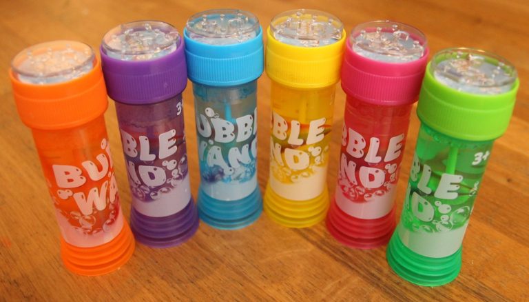 Sechs Flaschen mit Seifenblasen, in verschiedenen Farben: Orange, Lila, Blau, Pink, Gelb und Grün.
